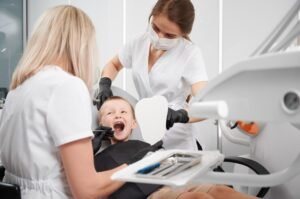 dentist assistant examining child teeth dental office 651396 1892